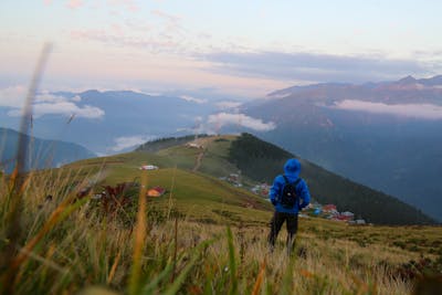 free photo of back view of a person standing on a mountain peak Best Hotels in Costa Rica