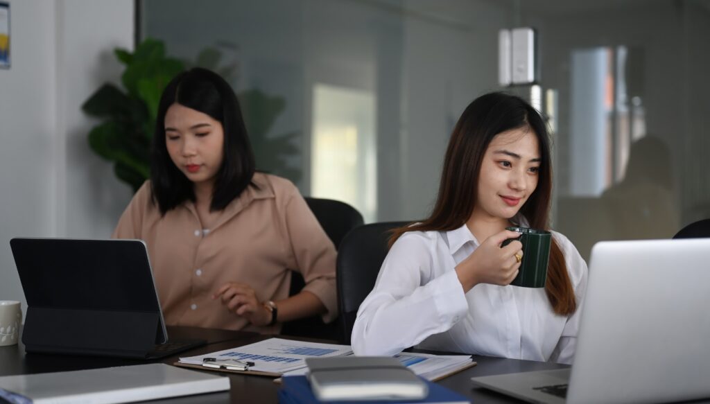 two confident businesswoman working and sitting together in modern office room UDyhkKd Z64 Work Culture in China