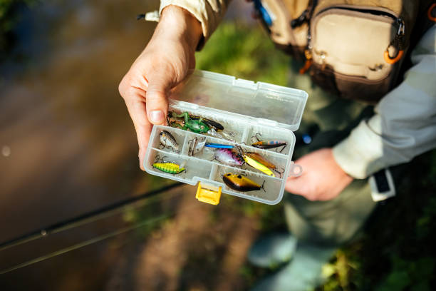 Man shows his baits that he is fishing on