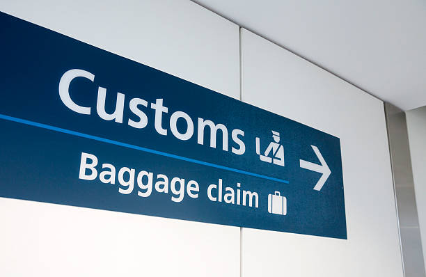 "Customs" and "Baggage Claim" direction sign at Sydney International Airport.