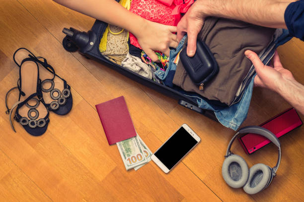 A man and a woman packing a suitcase or luggage for travel. Travel Concept